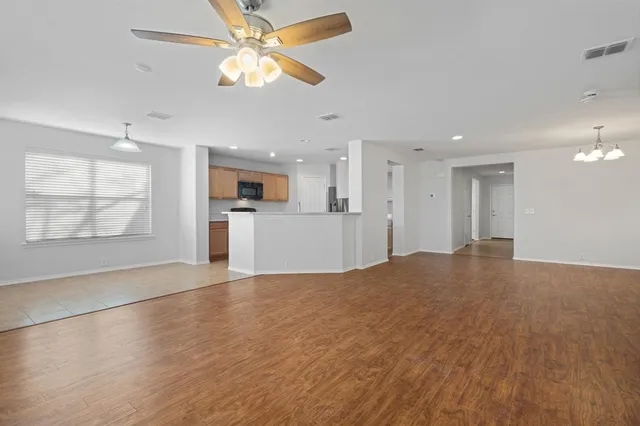 a view of a kitchen with a dishwasher cabinets and wooden floor