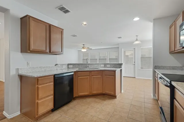 a kitchen with stainless steel appliances granite countertop a sink and a stove