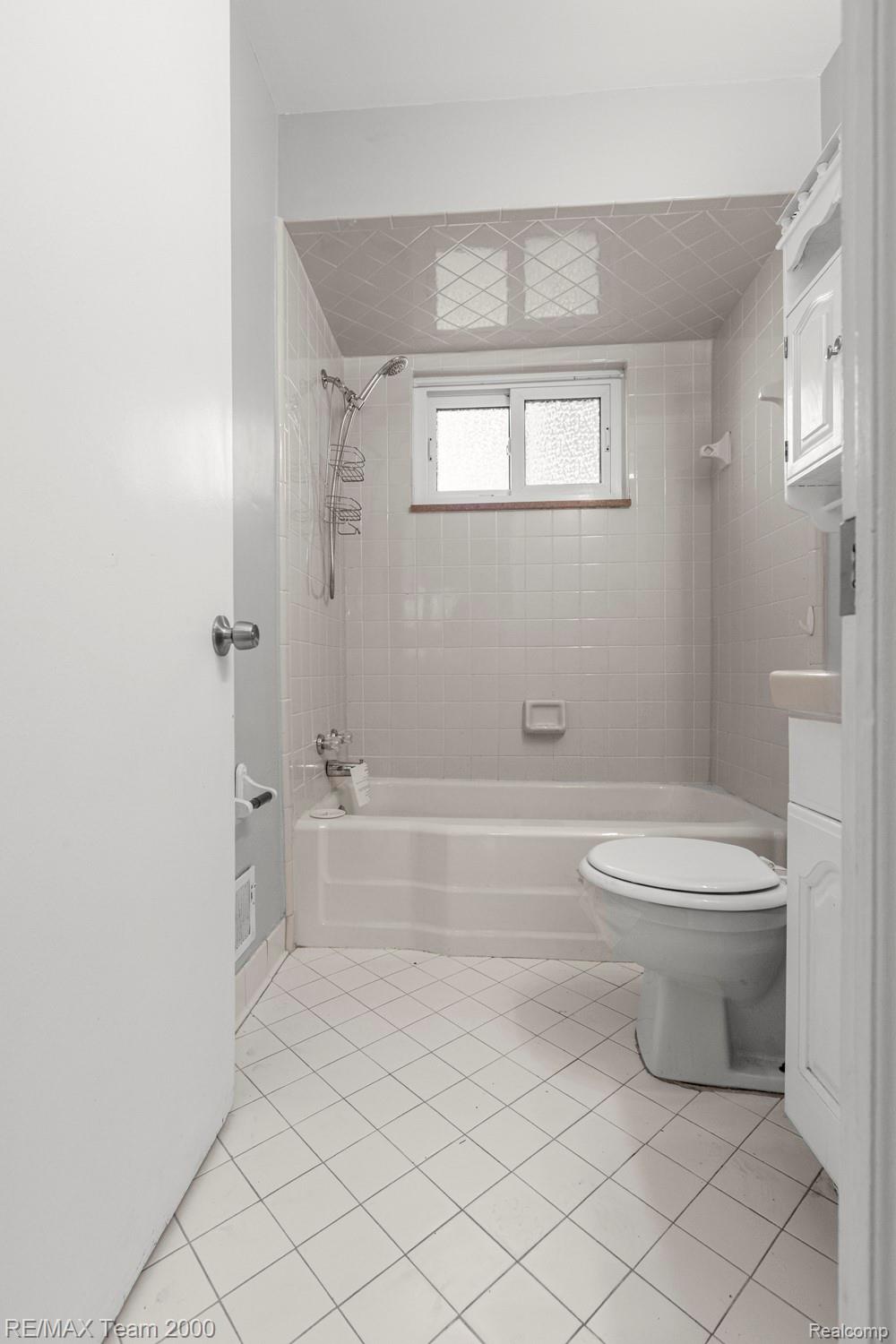 19431 Stephens Road Eastpointe, MI 48021 - Photo 25 of 46 Bathroom with light tile patterned flooring, shower combination, and vanity