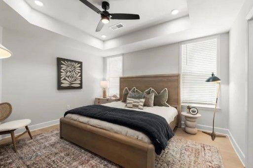 4770 Adairview Circle, Unit C Alpharetta, GA 30004 - Photo 5 of 7 a bedroom with a large bed and a chair