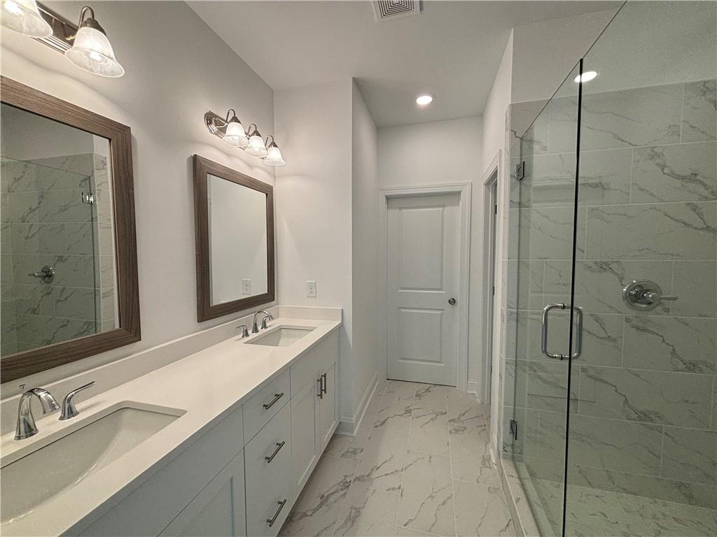 a bathroom with a double vanity sink mirror and double