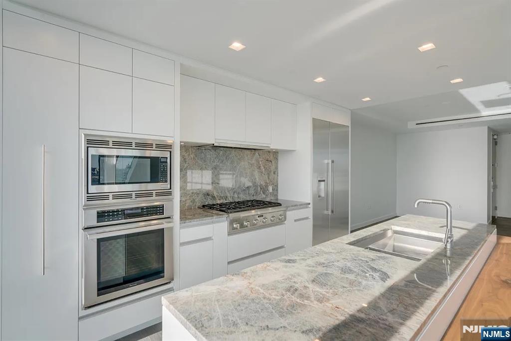 320 Adolphus Avenue, Unit 316 Cliffside Park, NJ 07010 - Photo 6 of 34 a kitchen with granite countertop cabinets stainless steel appliances and a counter space