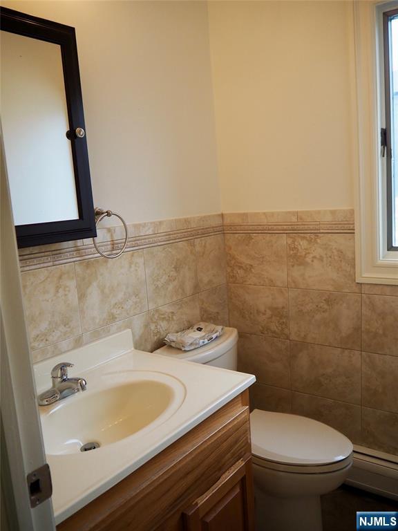 744 Hamilton Avenue, Unit 1 Ridgefield, NJ 07657 - Photo 24 of 29 a bathroom with a sink a toilet and mirror