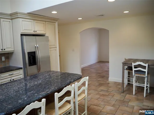 a kitchen with kitchen island a sink stainless steel appliances and cabinets