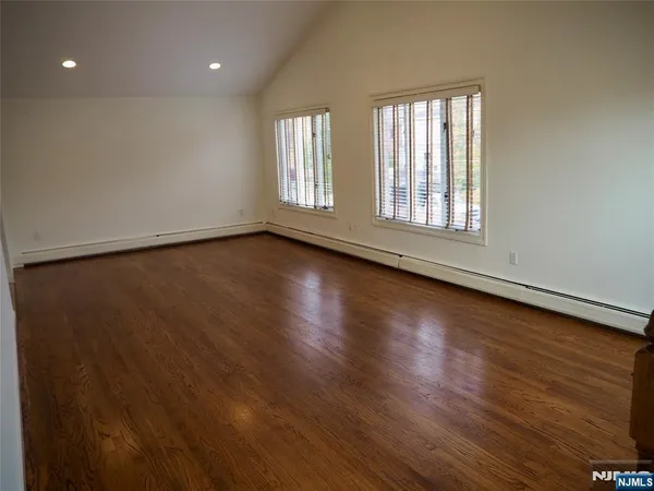 a view of staircase with wooden floor and windows