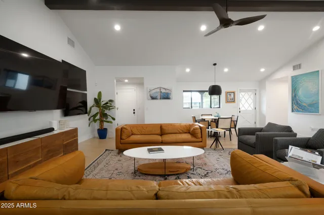 a living room with furniture and a view of kitchen