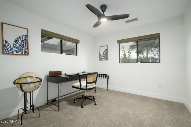 a view of a livingroom with furniture and windows