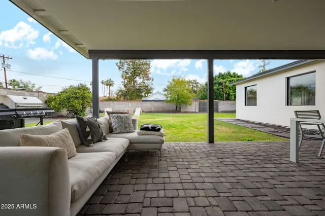 a living room with patio area and garden view