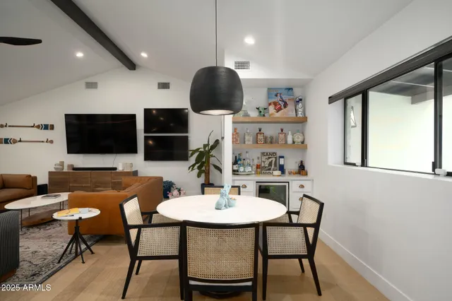 a dining room with furniture and wooden floor