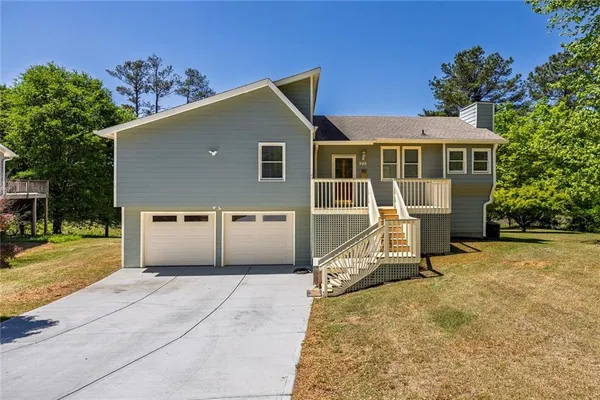a front view of a house with a yard and garage