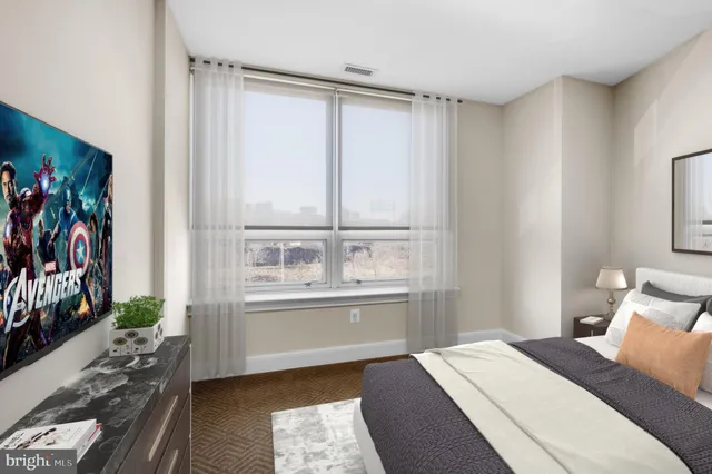 a kitchen with stainless steel appliances a refrigerator a stove a microwave and white cabinets