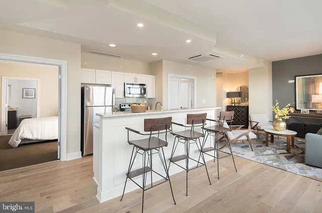 a kitchen with sink and wooden floor