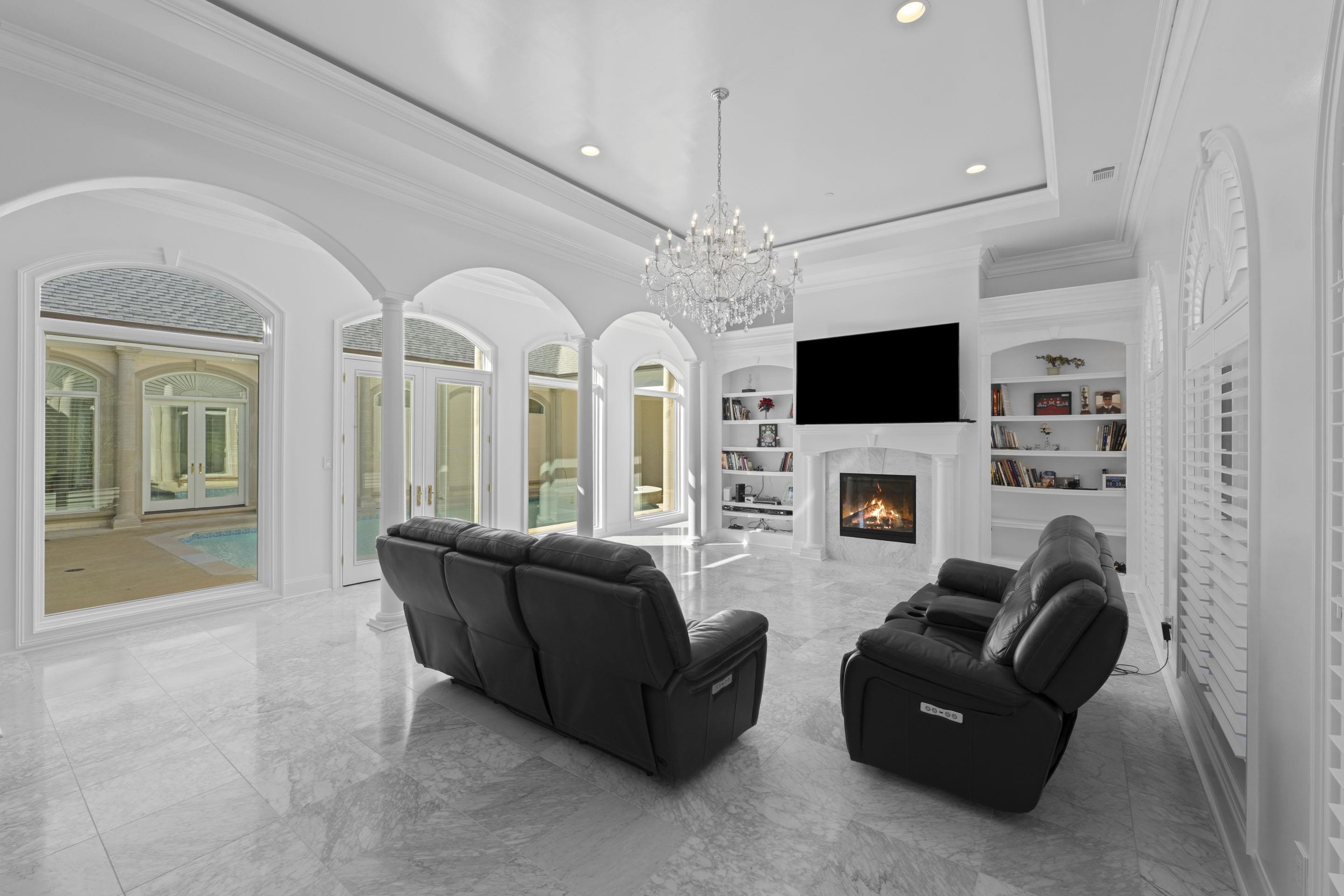 881 Bray Station Road Collierville, TN 38017 - Photo 9 of 40 Living room with a raised ceiling, ornamental molding, a high end fireplace, marble tiled floors, and a chandelier