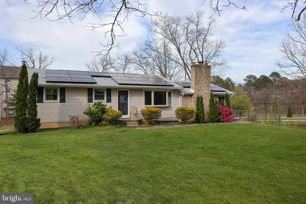 a front view of a house with a garden and yard