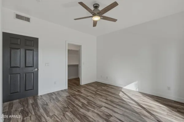 a view of an empty room with wooden floor