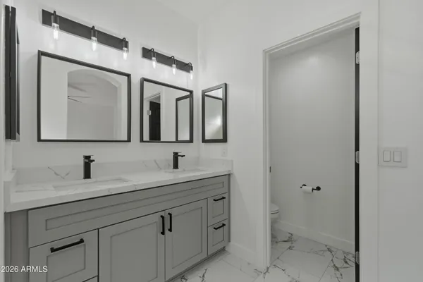 a bathroom with a tub a sink and mirror
