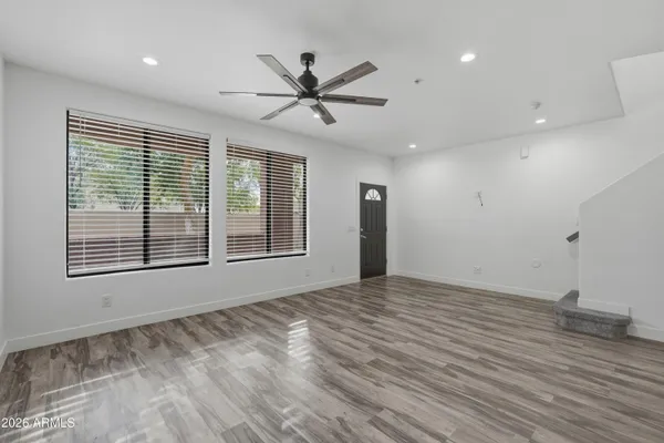 a view of an empty room and wooden floor