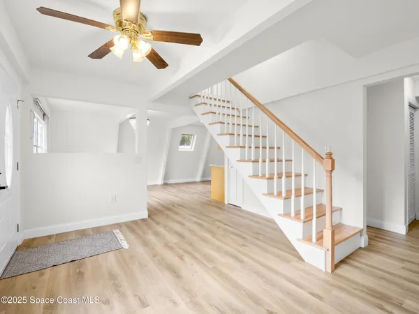 a view of an entryway with wooden floor