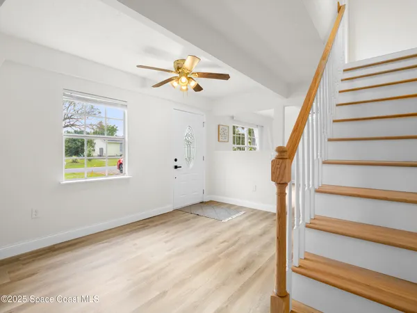 a view of an entryway with wooden floor and a window