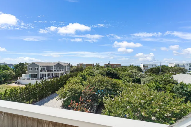 a view of a small house with backyard porch and wooden floor