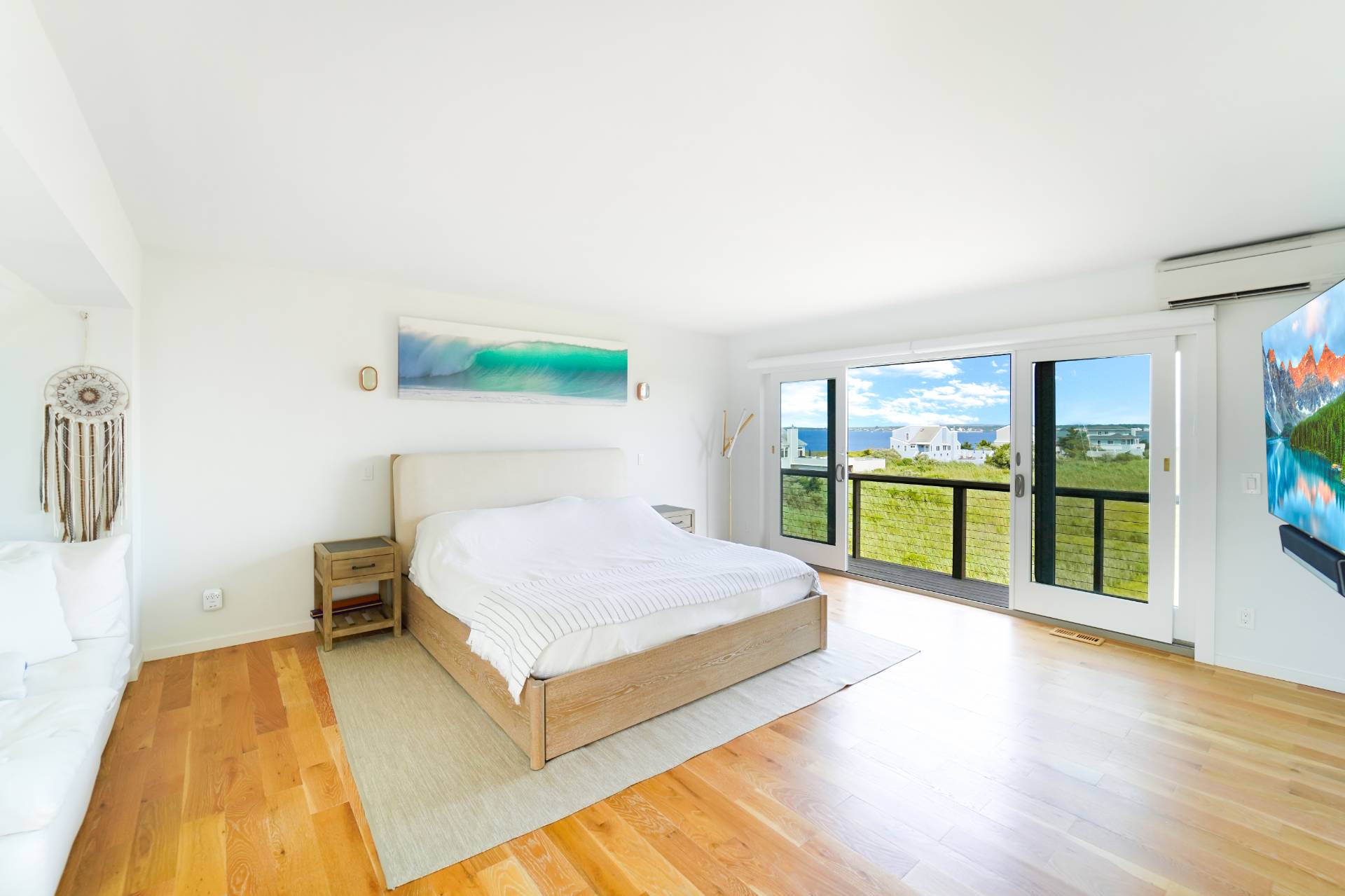 548 Dune Road Westhampton, NY 11978 - Photo 15 of 34 a spacious bedroom with a bed and large window