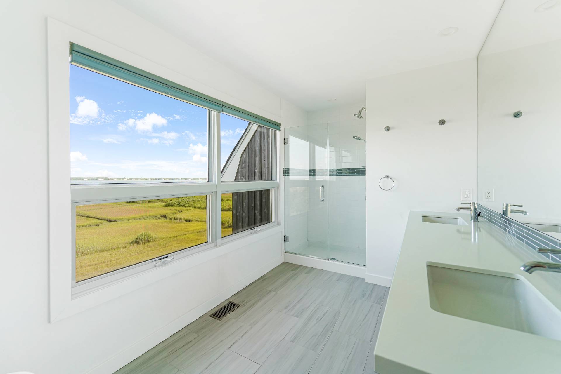 548 Dune Road Westhampton, NY 11978 - Photo 16 of 34 a kitchen with stainless steel appliances wooden floor and a large window