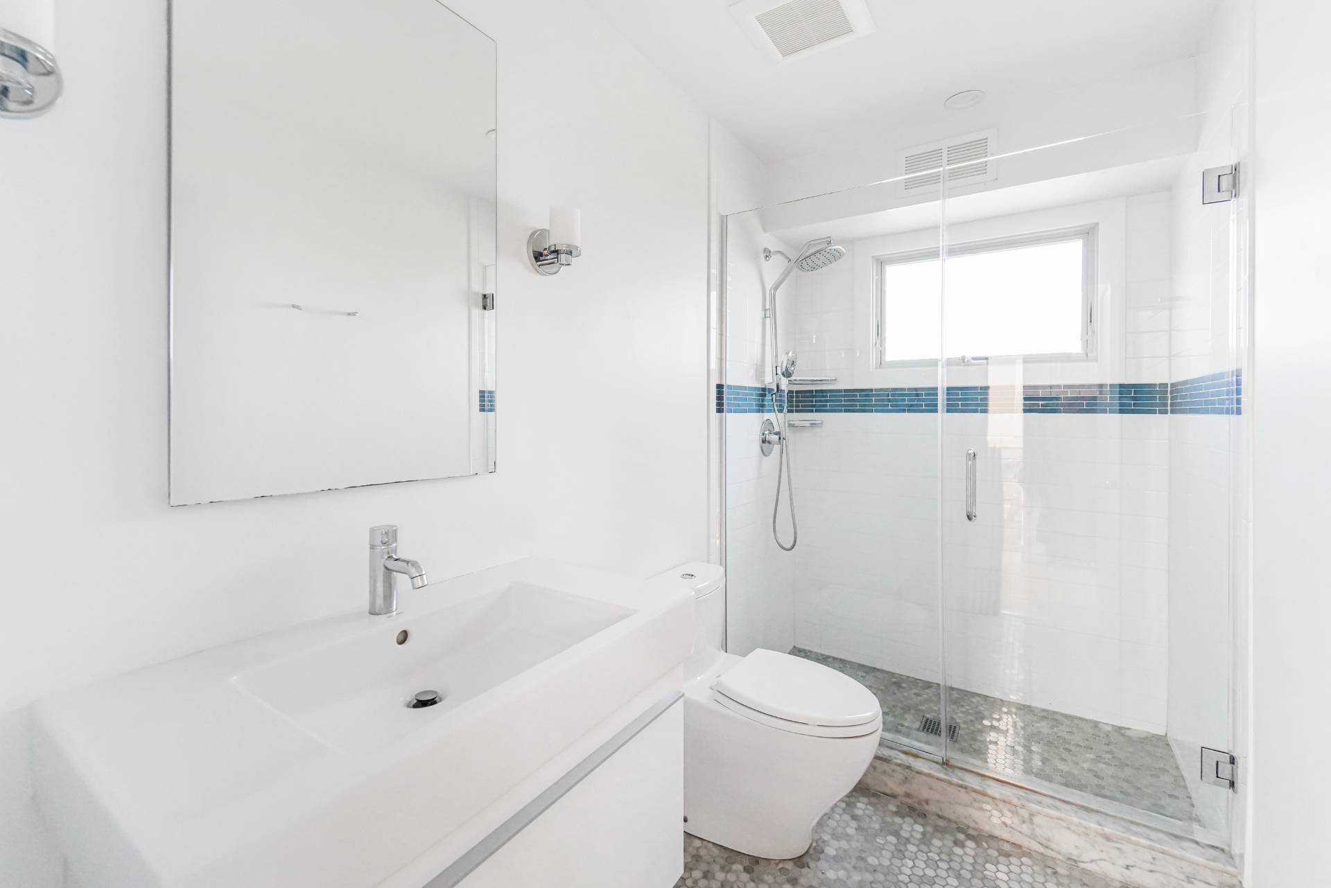 548 Dune Road Westhampton, NY 11978 - Photo 20 of 34 a bathroom with a sink and a large mirror