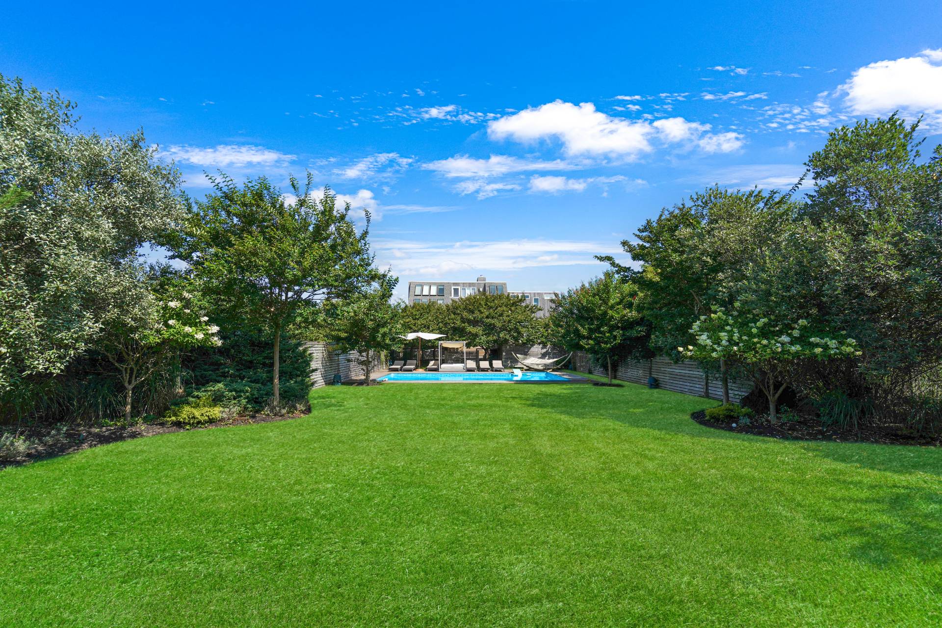 548 Dune Road Westhampton, NY 11978 - Photo 25 of 34 a view of a big yard with a large tree