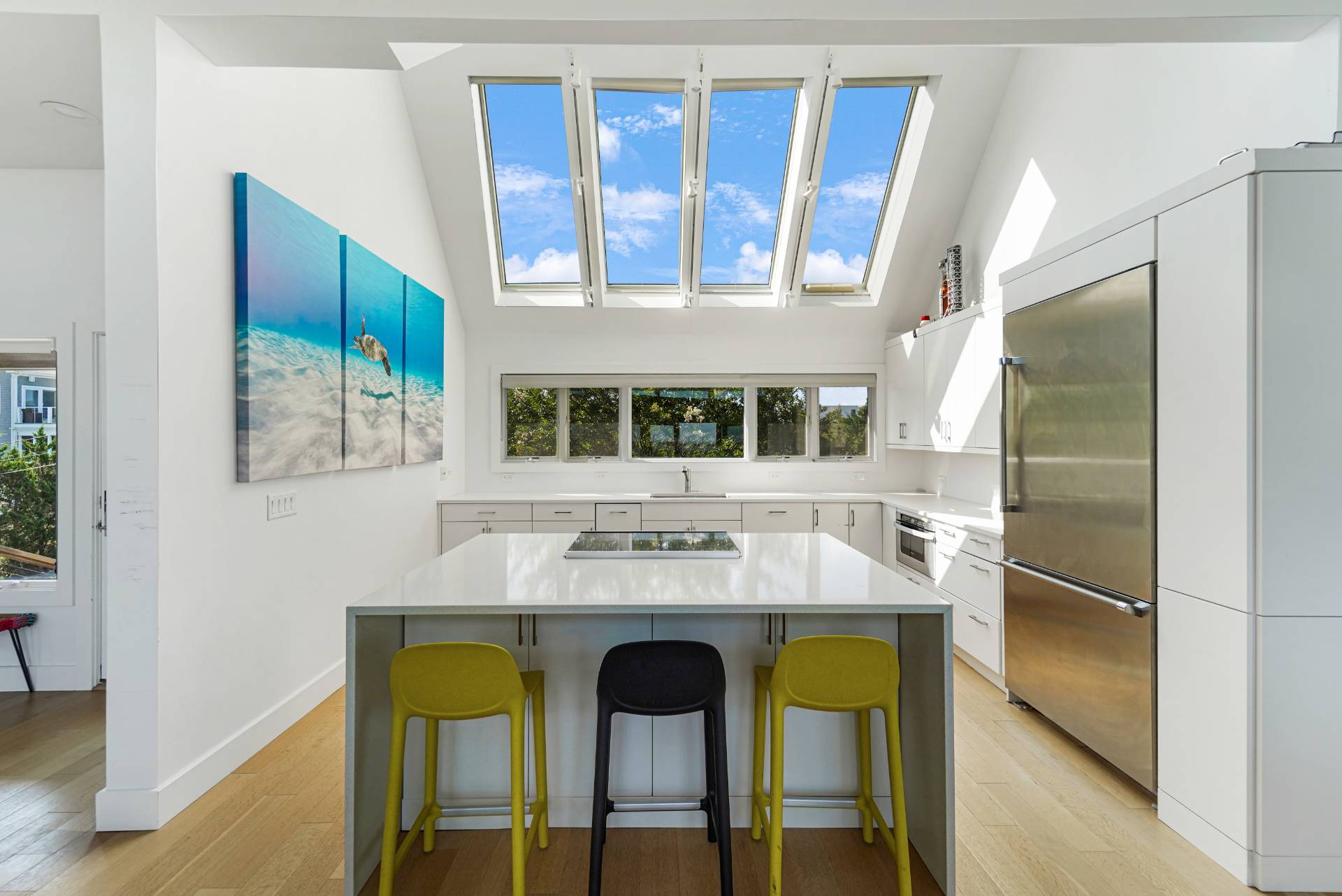 548 Dune Road Westhampton, NY 11978 - Photo 7 of 34 a kitchen with a counter and a refrigerator