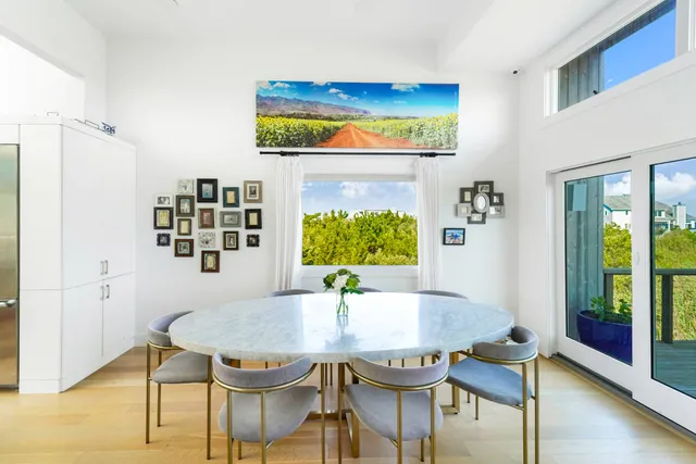 a view of a dining room with furniture and a window