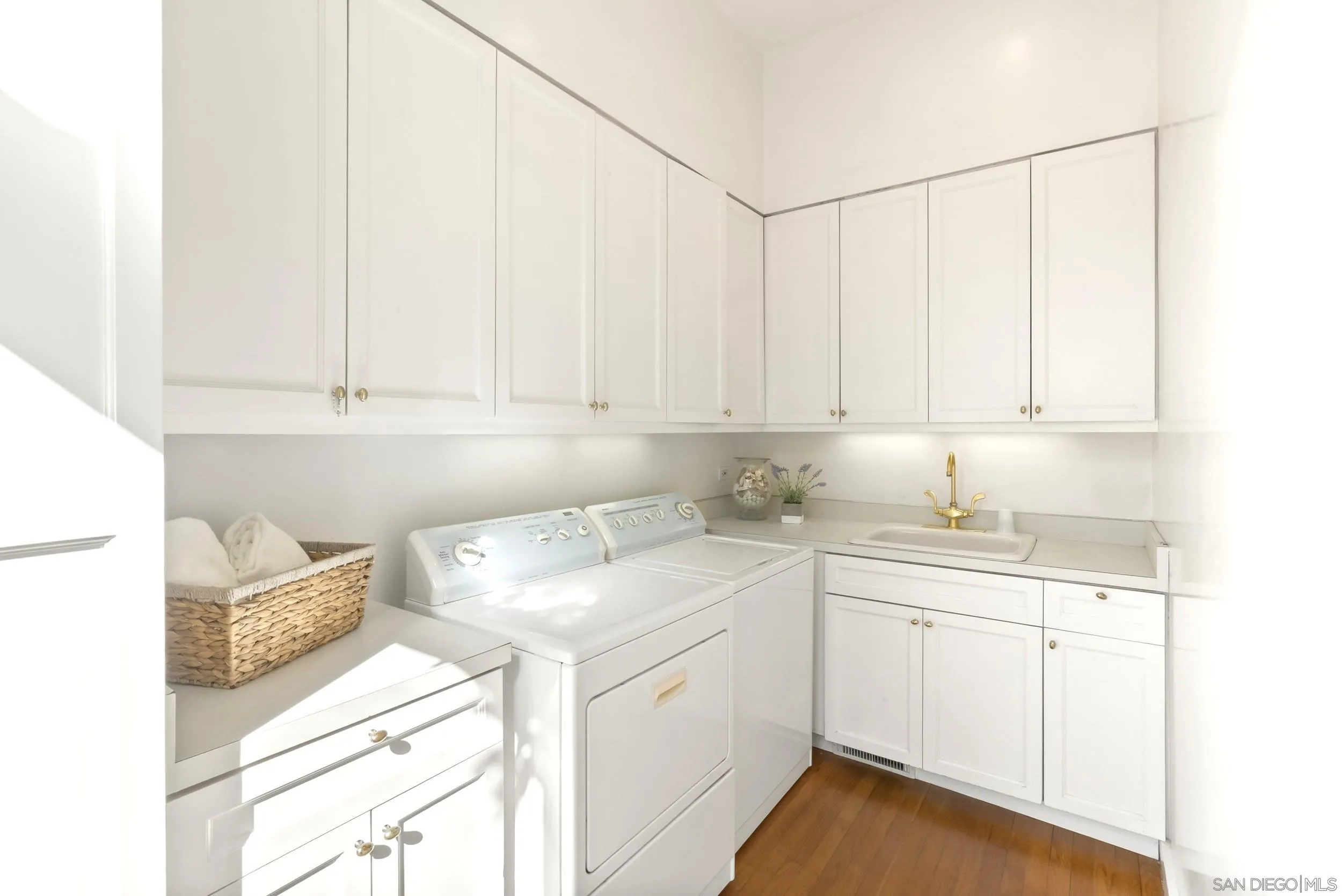 2302 Rue Adriane La Jolla, CA 92037 - Photo 11 of 31 a utility room with cabinets washer and dryer
