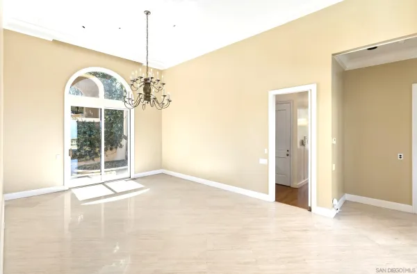 a view of a room with large windows and pool table