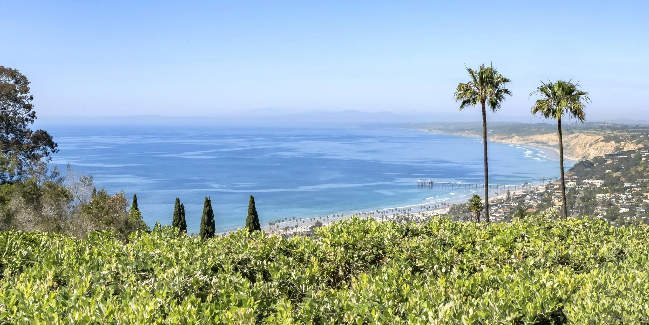 2302 Rue Adriane La Jolla, CA 92037 - Photo 6 of 31 a view of a garden with a building in the background