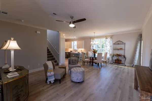 a kitchen with a refrigerator and a view of living room