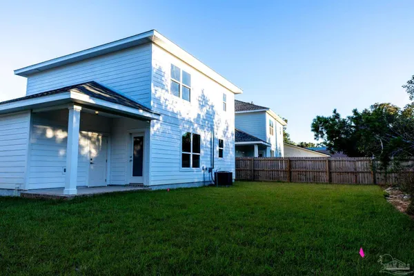 a view of front door of house with a yard