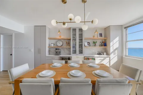 a view of a dining room with furniture and a chandelier