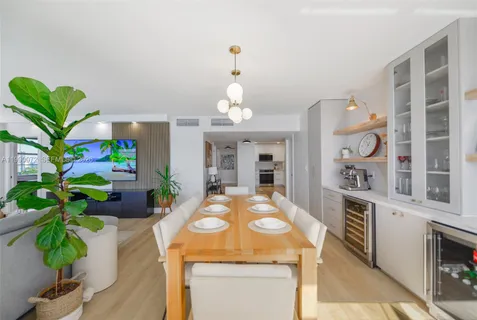 a living room with furniture and a kitchen view