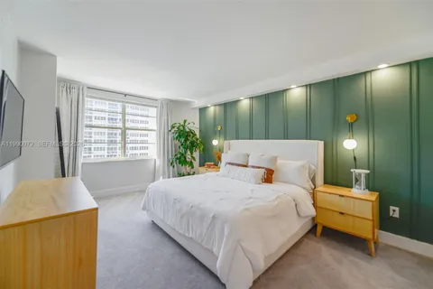 a bedroom with a bed wooden floor and window