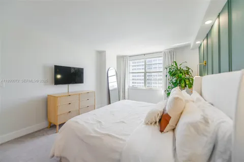 a view of walk in closet with clothes
