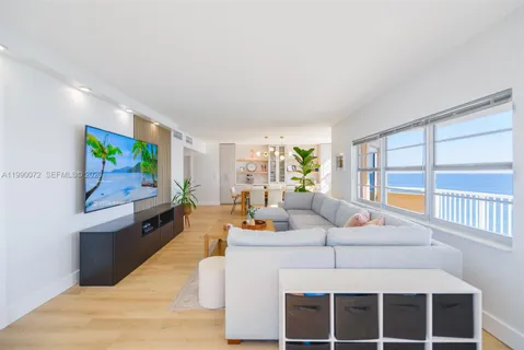 a living room with furniture tv and a large window
