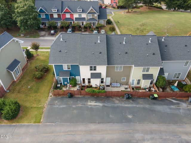 a view of a swimming pool with a bench and trees around