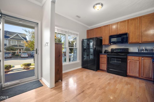 a kitchen with stainless steel appliances granite countertop a stove a sink dishwasher a refrigerator and a microwave oven