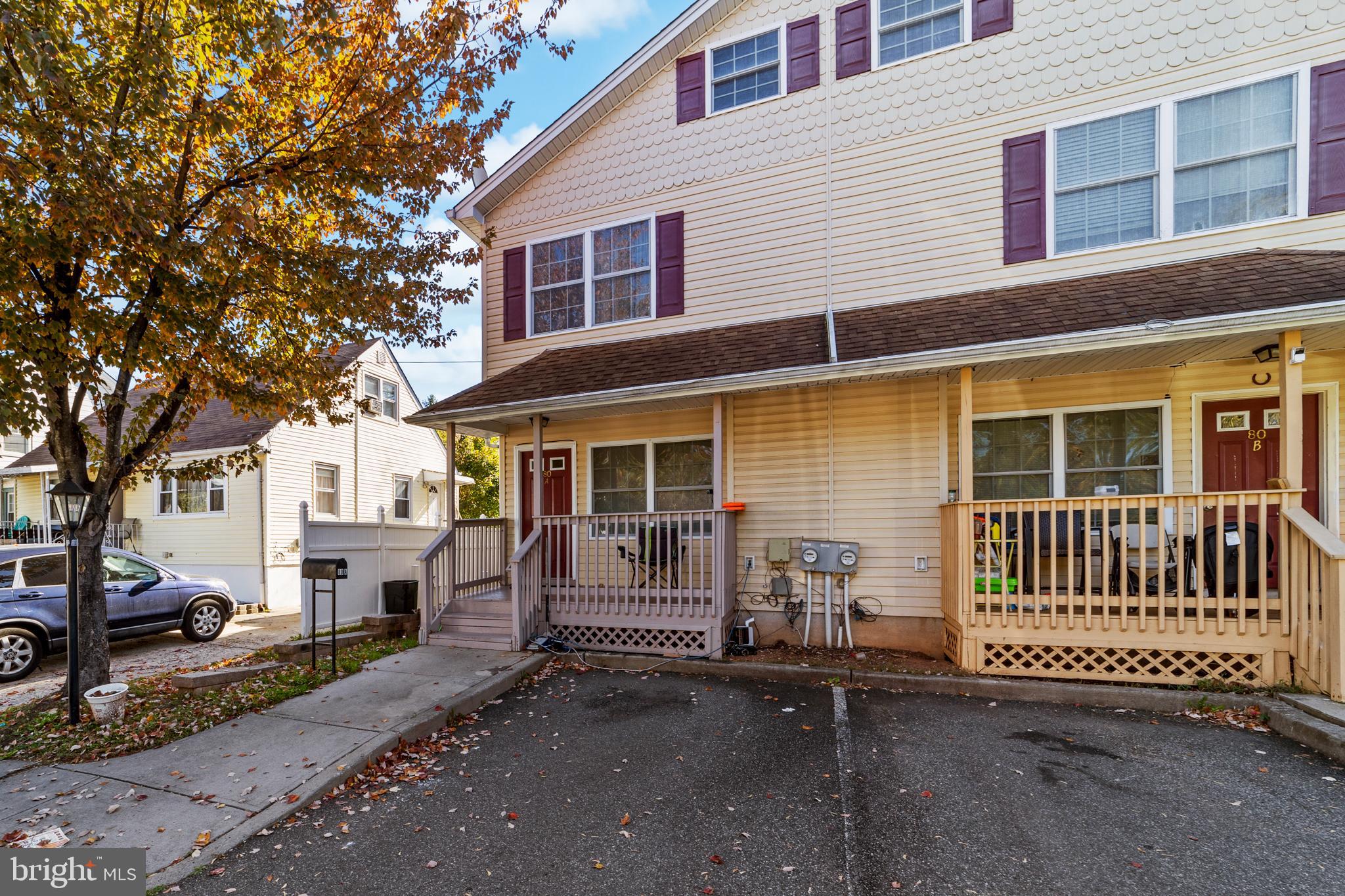80 Larch Avenue New Brunswick, NJ 08901 - Photo 1 of 24 a view of a house with a wooden fence and large trees