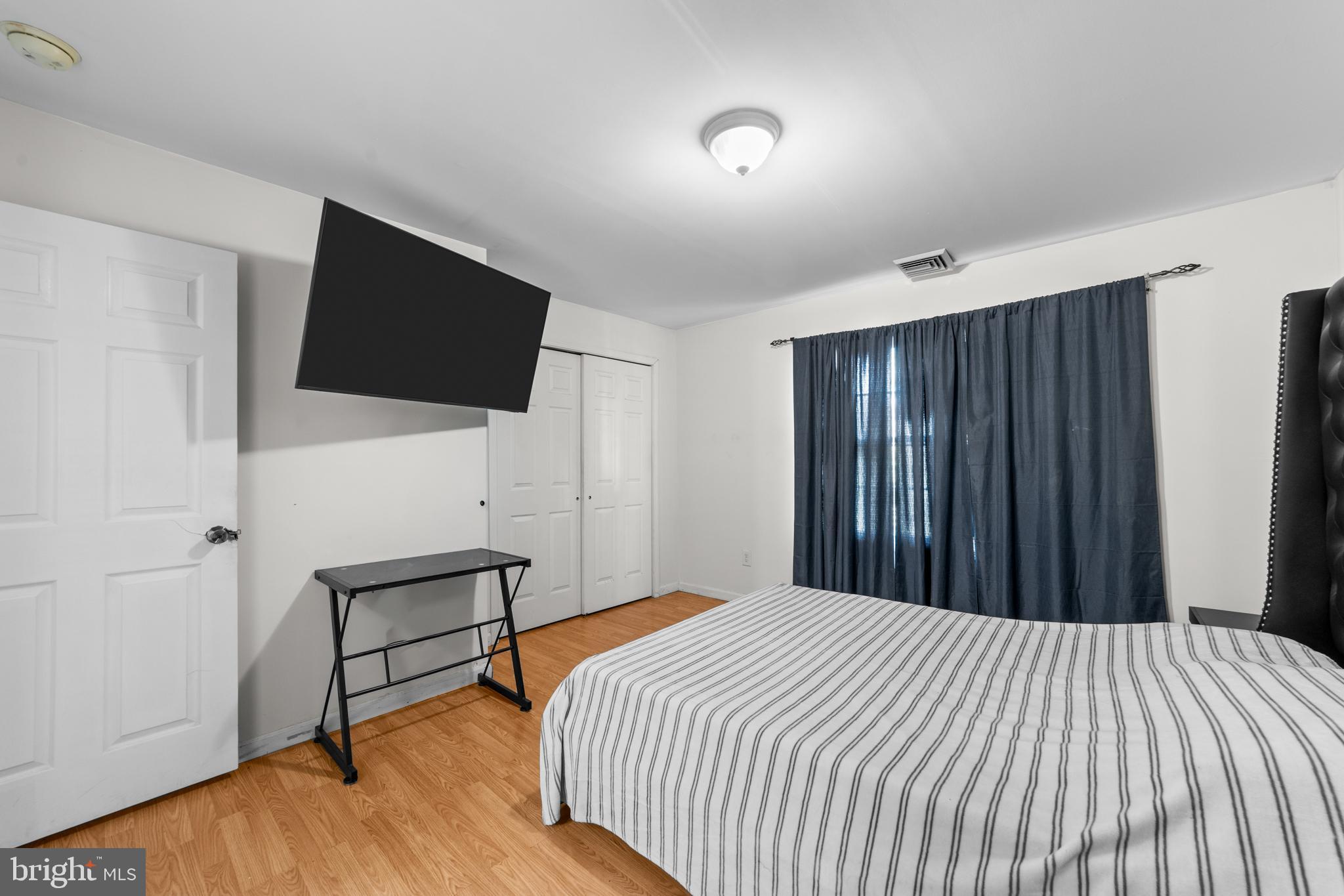 80 Larch Avenue New Brunswick, NJ 08901 - Photo 16 of 24 a bedroom with a bed and a flat screen tv