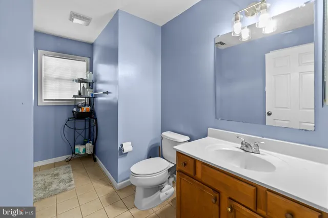 a bathroom with a sink a toilet and mirror