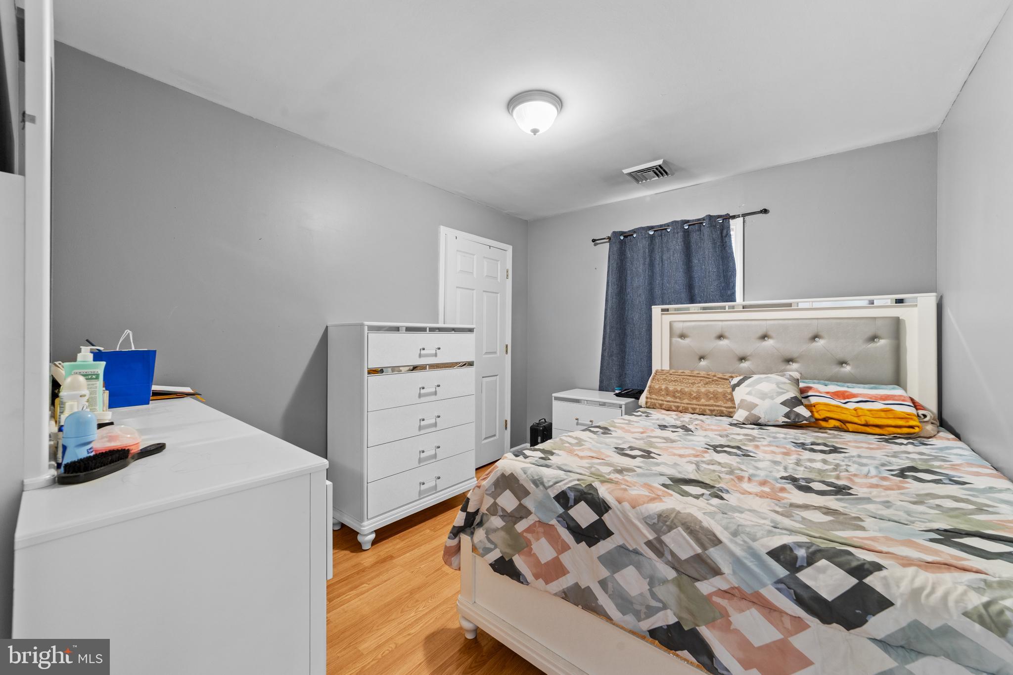 80 Larch Avenue New Brunswick, NJ 08901 - Photo 20 of 24 a bedroom with a bed and a lamp