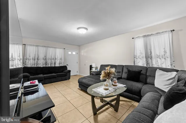 a living room with furniture a rug and a flat screen tv
