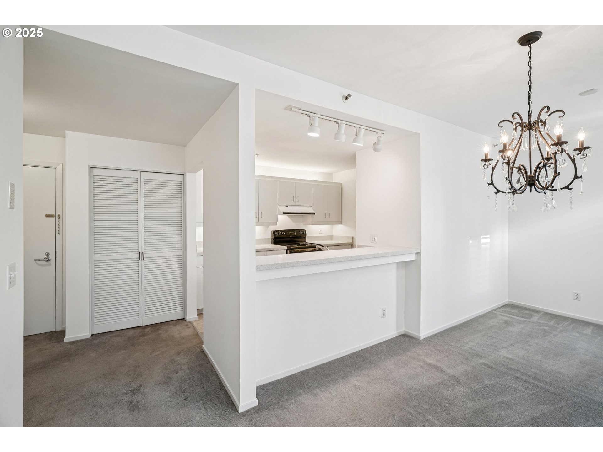 1616 South Harbor Way, Unit 402 Portland, OR 97201 - Photo 11 of 34 a kitchen view with white cabinets and stainless steel appliances