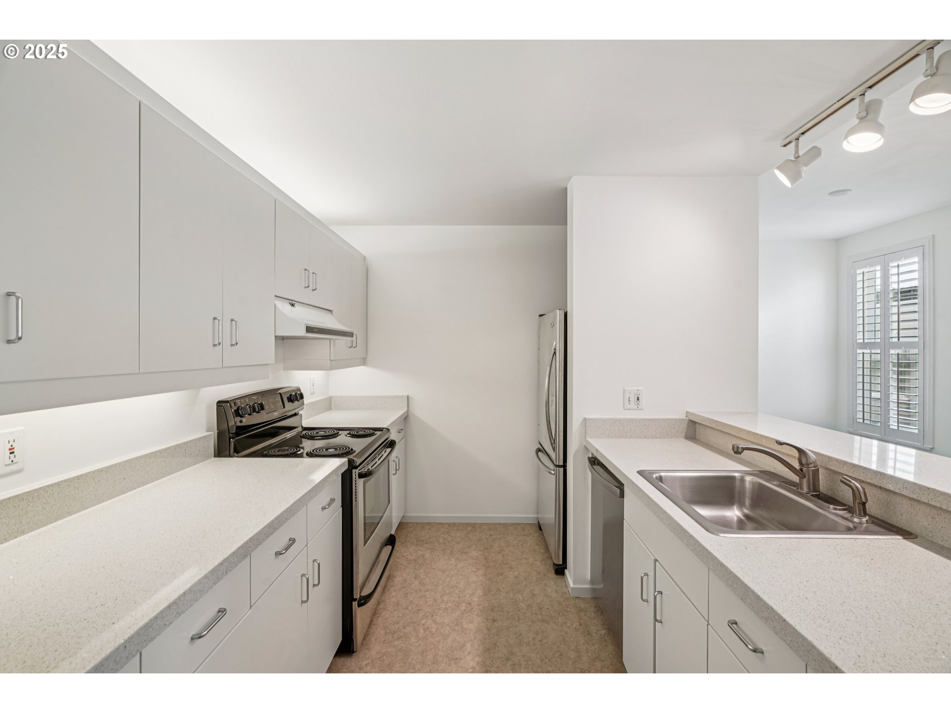 1616 South Harbor Way, Unit 402 Portland, OR 97201 - Photo 14 of 34 a kitchen with a sink stove top oven and cabinets