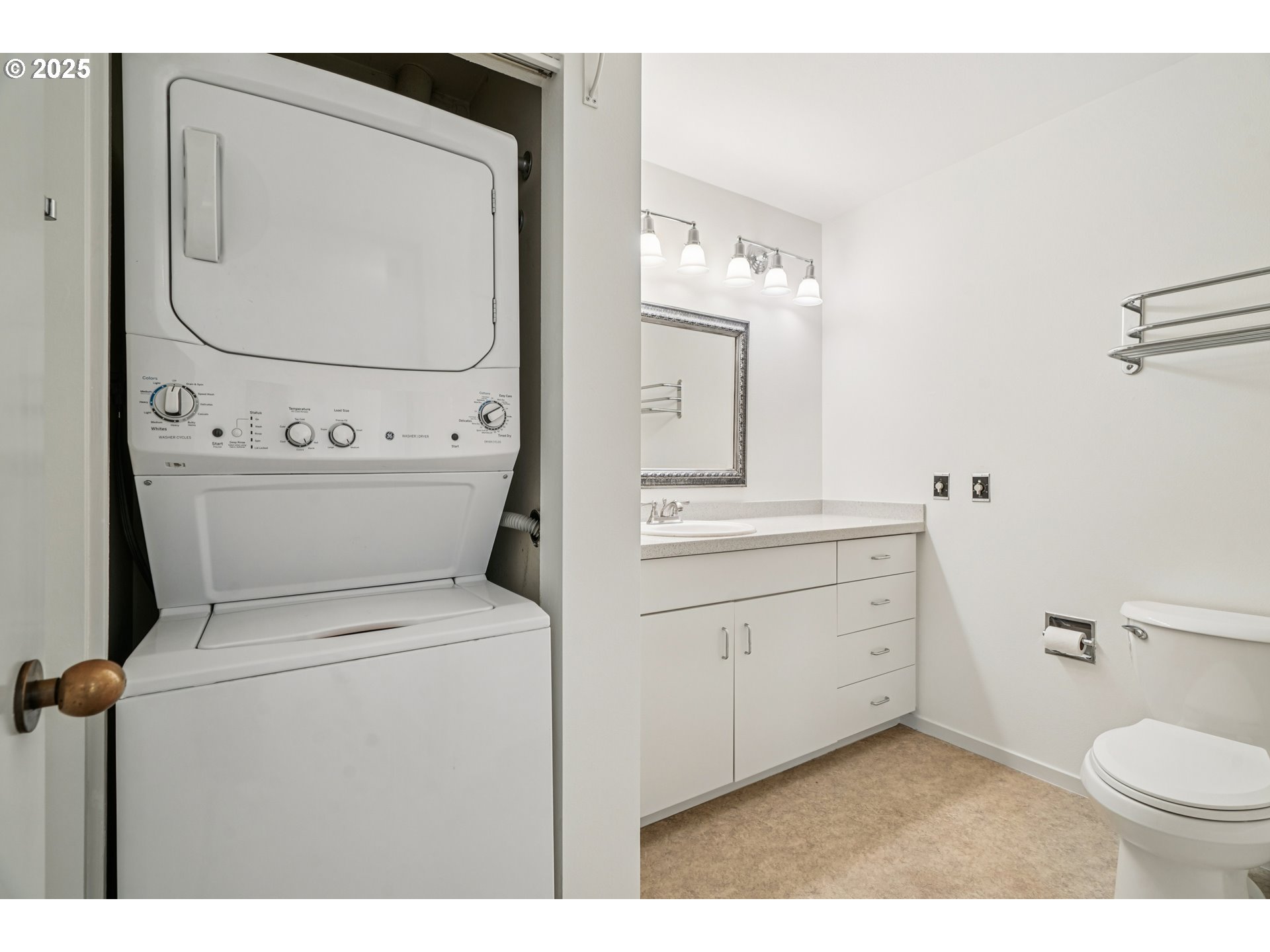 1616 South Harbor Way, Unit 402 Portland, OR 97201 - Photo 19 of 34 a bathroom with a toilet sink vanity and mirror
